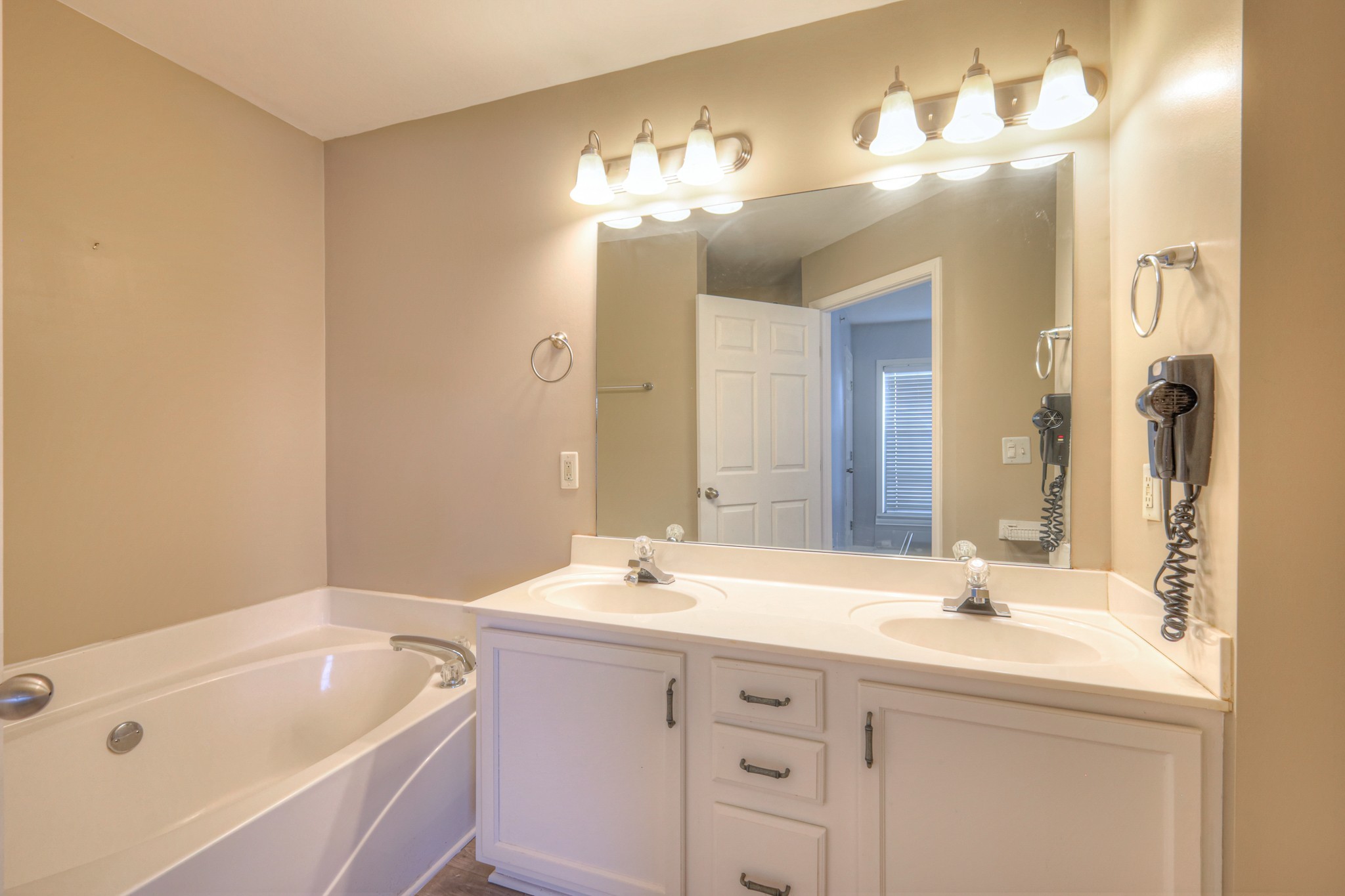 4027 Clinton Lane Spring Hill, TN 37174 - Photo 17 of 25 a bathroom with a tub a sink and a large mirror