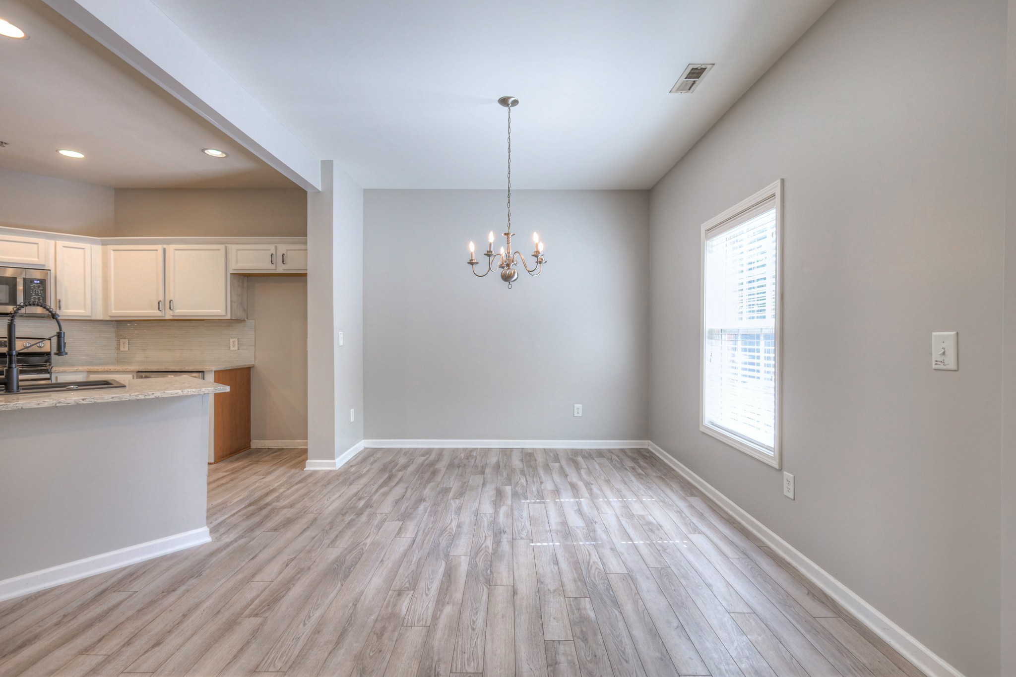 4027 Clinton Lane Spring Hill, TN 37174 - Photo 4 of 25 a view of a kitchen with a sink wooden floor and a window