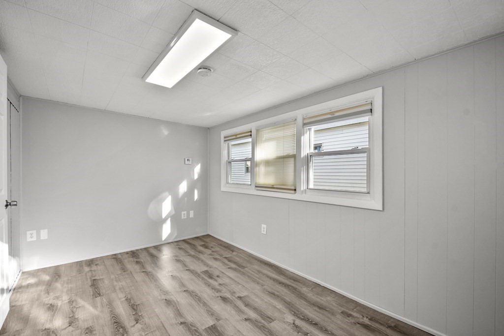 40 Eldorado Drive Marlborough, MA 01752 - Photo 14 of 26 an empty room with wooden floor and windows