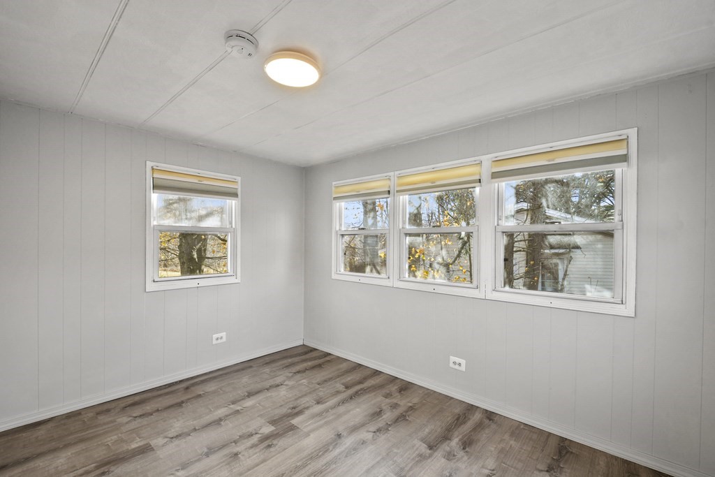 40 Eldorado Drive Marlborough, MA 01752 - Photo 18 of 26 a view of an empty room with wooden floor and a window