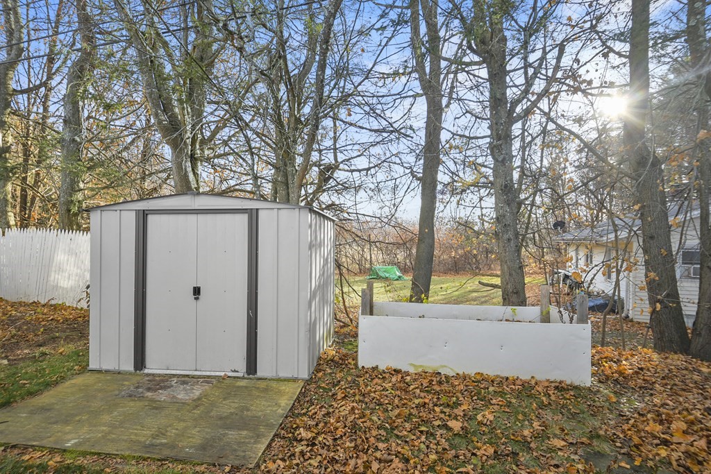 40 Eldorado Drive Marlborough, MA 01752 - Photo 25 of 26 a view of a house with a large tree and wooden fence