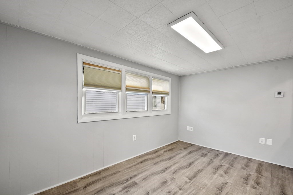 40 Eldorado Drive Marlborough, MA 01752 - Photo 3 of 26 an empty room with wooden floor and windows