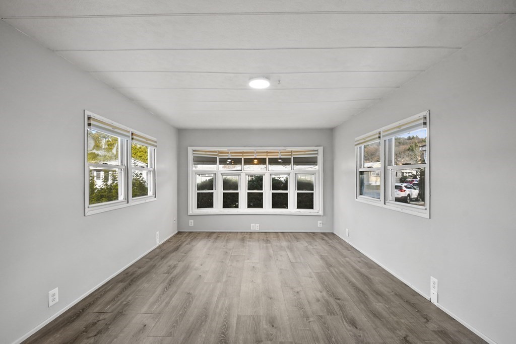 40 Eldorado Drive Marlborough, MA 01752 - Photo 8 of 26 a view of an empty room with wooden floor and a window