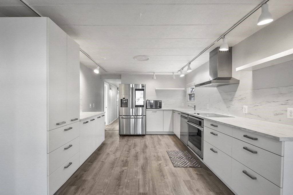 40 Eldorado Drive Marlborough, MA 01752 - Photo 9 of 26 a large white kitchen with cabinets