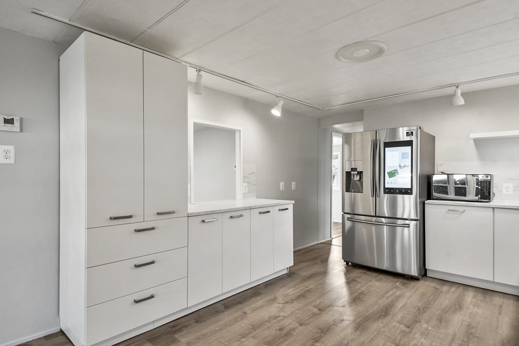40 Eldorado Drive Marlborough, MA 01752 - Photo 10 of 26 a kitchen with white cabinets and refrigerator