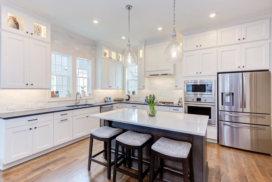 1017 Bradburn Drive Durham, NC 27713 - Photo 11 of 34 a kitchen with granite countertop white cabinets and stainless steel appliances