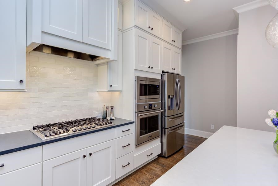 1017 Bradburn Drive Durham, NC 27713 - Photo 14 of 34 a kitchen with stainless steel appliances a cabinets and stove top oven