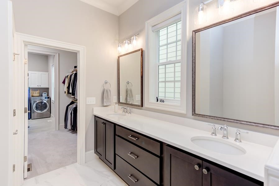 1017 Bradburn Drive Durham, NC 27713 - Photo 18 of 34 a en suite bathroom with a double vanity sink and a mirror