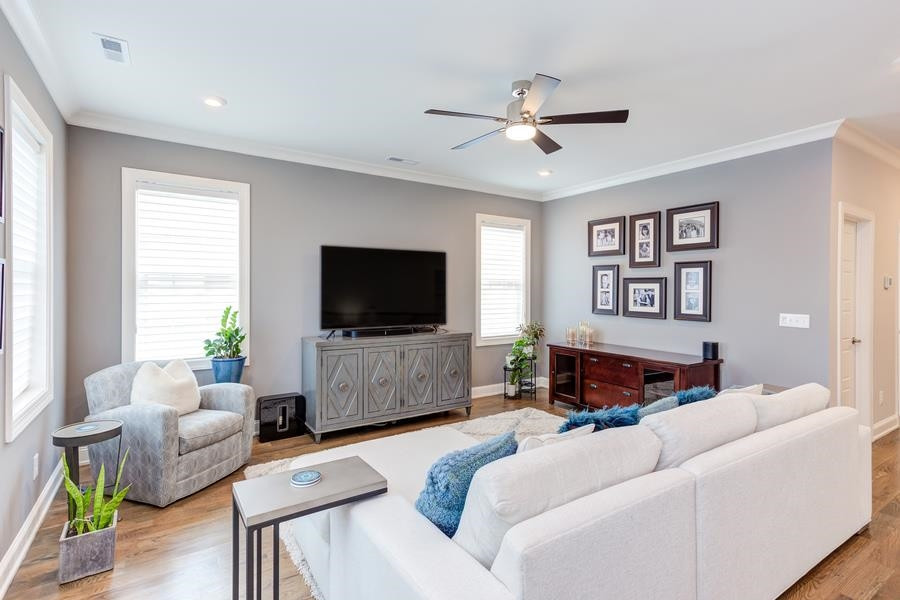 1017 Bradburn Drive Durham, NC 27713 - Photo 24 of 34 a living room with furniture and a flat screen tv