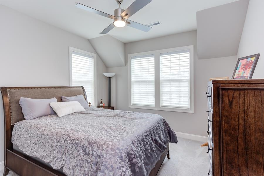 1017 Bradburn Drive Durham, NC 27713 - Photo 30 of 34 a bedroom with a large bed and a window