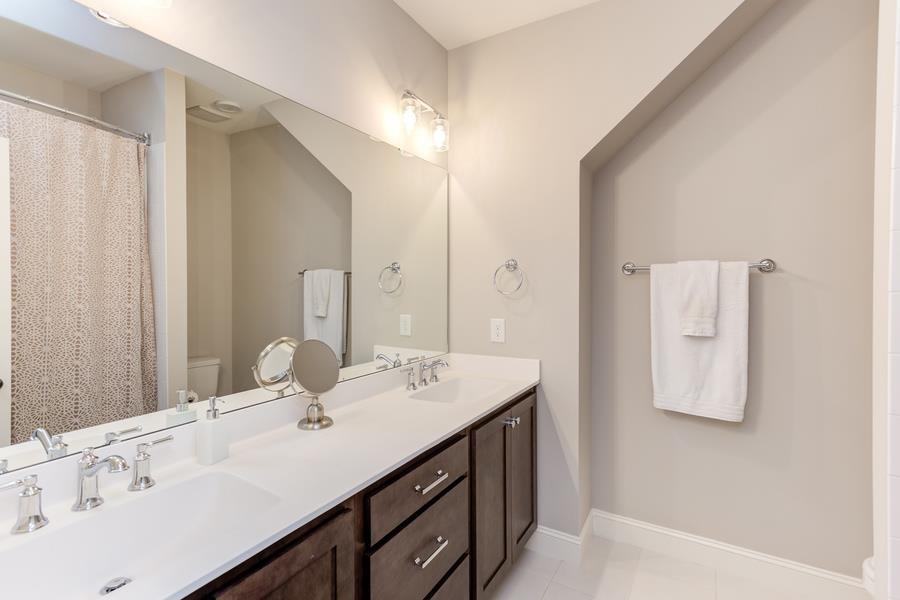 1017 Bradburn Drive Durham, NC 27713 - Photo 31 of 34 a bathroom with a sink and a mirror