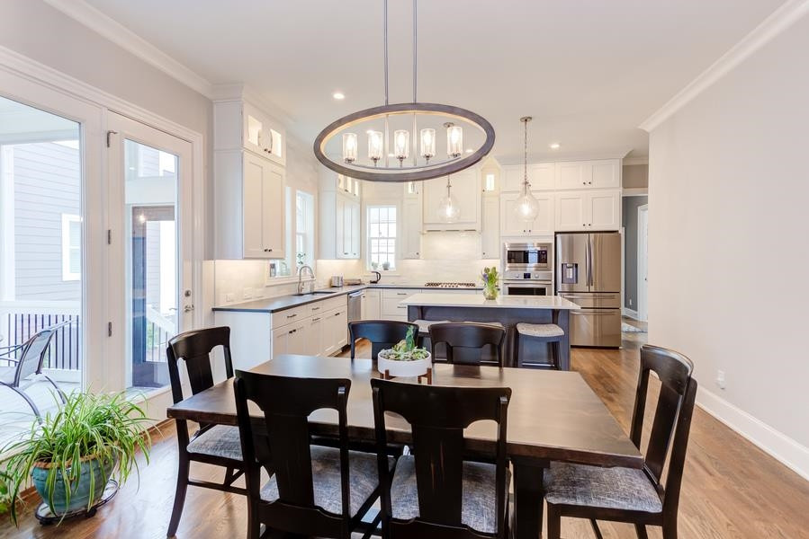 1017 Bradburn Drive Durham, NC 27713 - Photo 6 of 34 a view of a dining room with furniture window and wooden floor