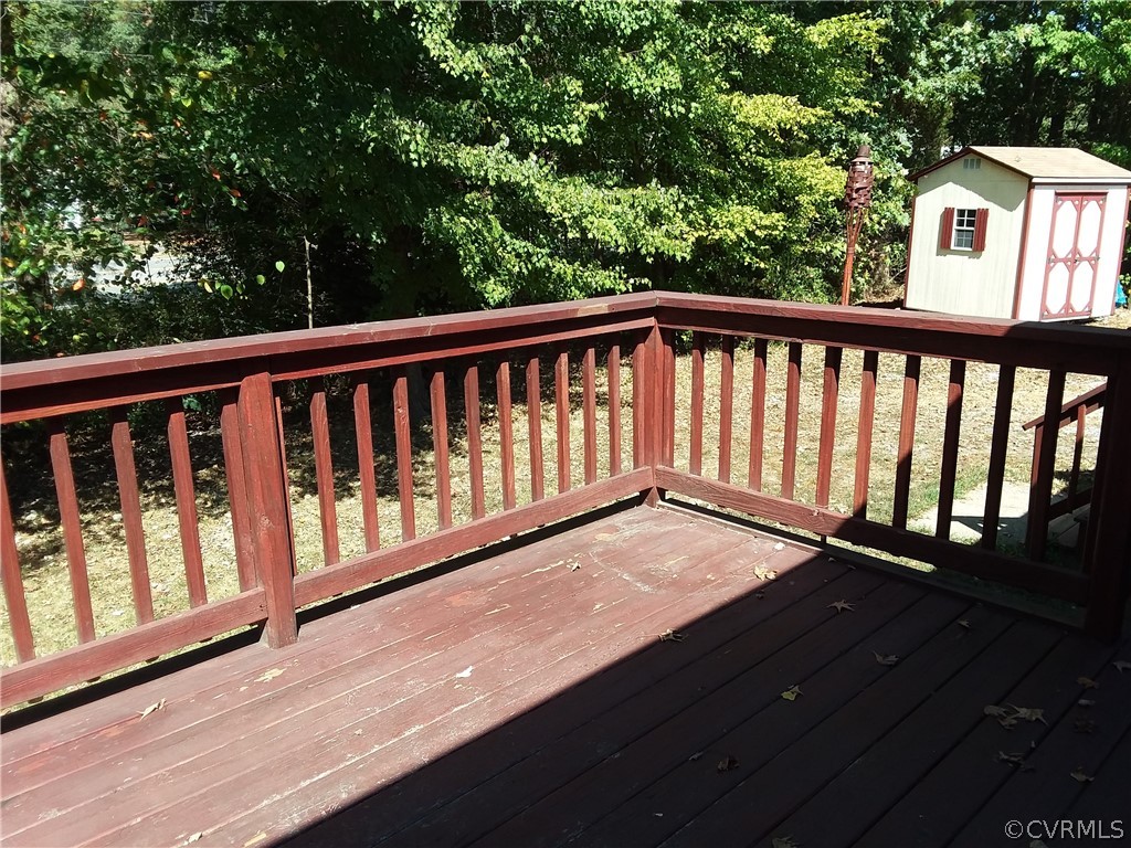 5302 Ridgerun Place Chesterfield, VA 23832 - Photo 16 of 16 a balcony with wooden floor and trees in the background