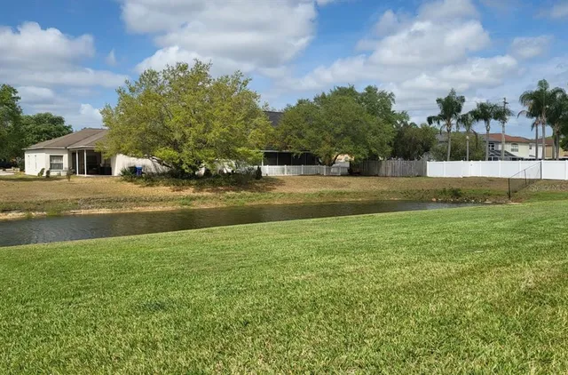 a view of big yard with a house in the background