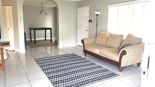 a living room with a couch and a table with wooden floor