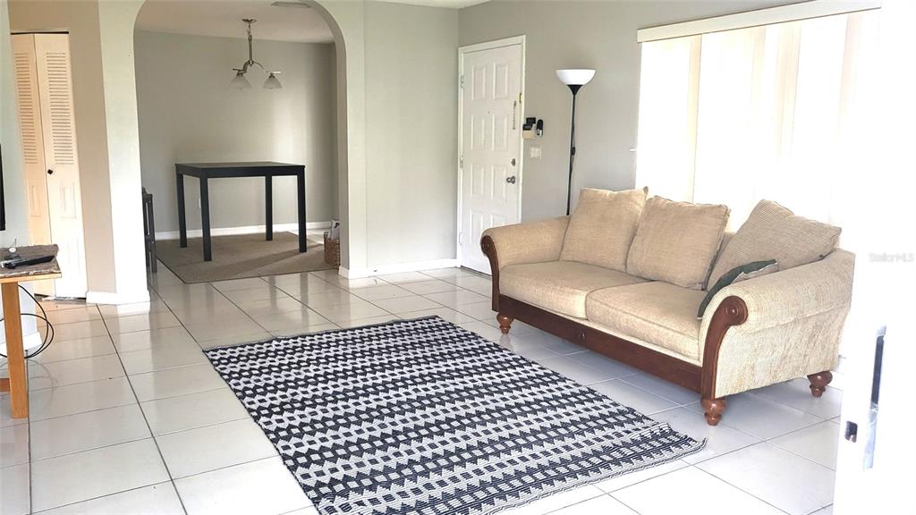 721 Kensington Lake Circle Brandon, FL 33511 - Photo 3 of 15 a living room with a couch and a table with wooden floor