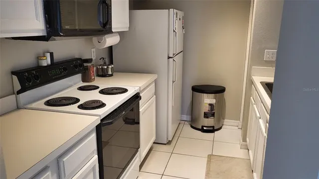 a kitchen with a sink a stove and a refrigerator