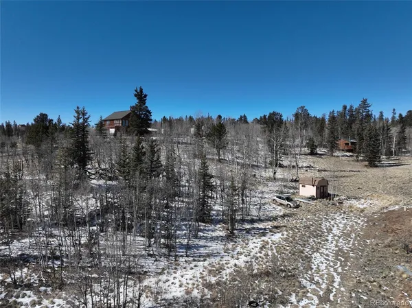 a view of a town with trees in the background