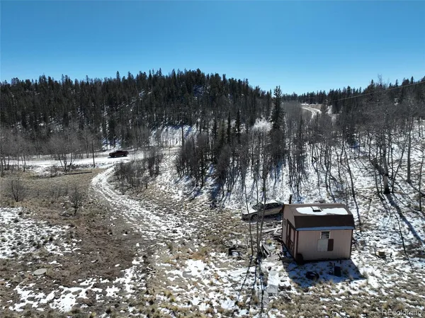 a view of a backyard with sitting area