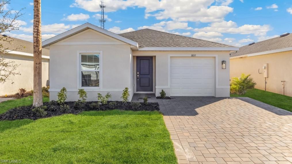 8022 Cedar Ky Way Lehigh Acres, FL 33971 - Photo 1 of 45 a front view of a house with a yard