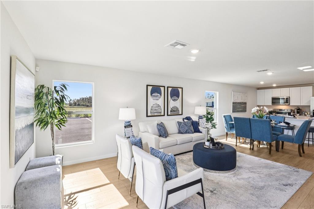 8022 Cedar Ky Way Lehigh Acres, FL 33971 - Photo 4 of 45 a living room with furniture potted plant and a table