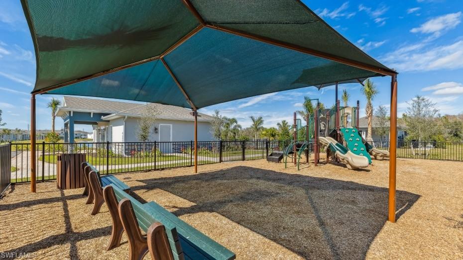 8022 Cedar Ky Way Lehigh Acres, FL 33971 - Photo 43 of 45 a view of a patio with a table and chairs under an umbrella