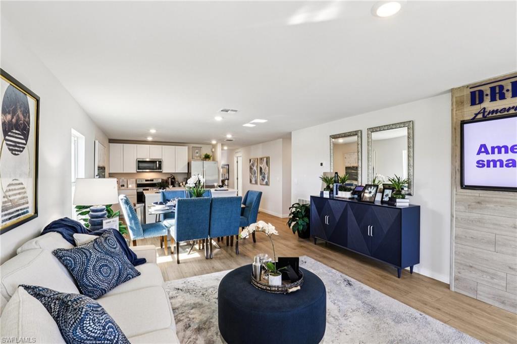 8022 Cedar Ky Way Lehigh Acres, FL 33971 - Photo 6 of 45 a living room with furniture and a dining room