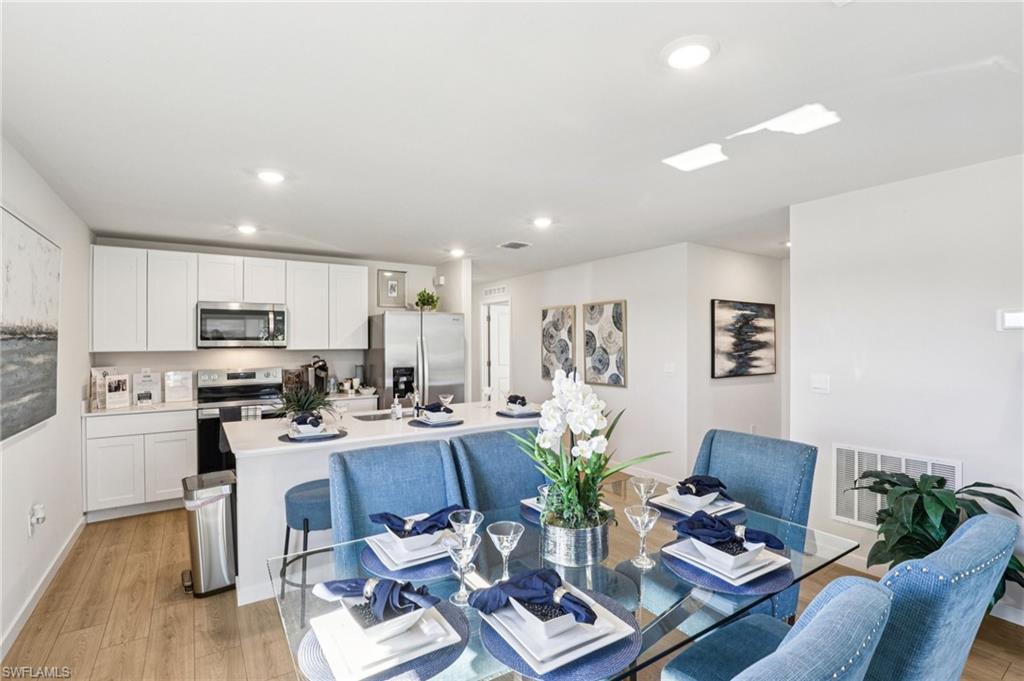 8022 Cedar Ky Way Lehigh Acres, FL 33971 - Photo 7 of 45 a living room with furniture and kitchen view