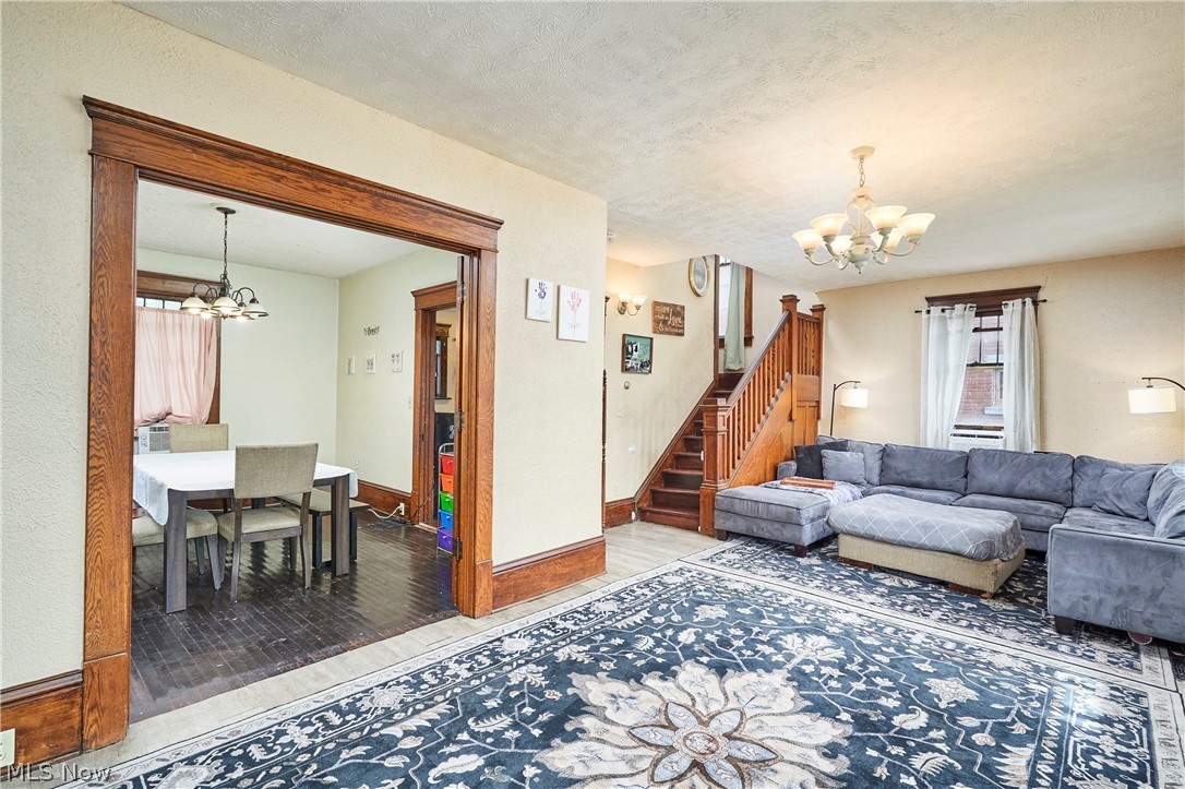 136 Smith Avenue Northwest Canton, OH 44708 - Photo 6 of 19 Living room featuring light-colored walls and a chandelier