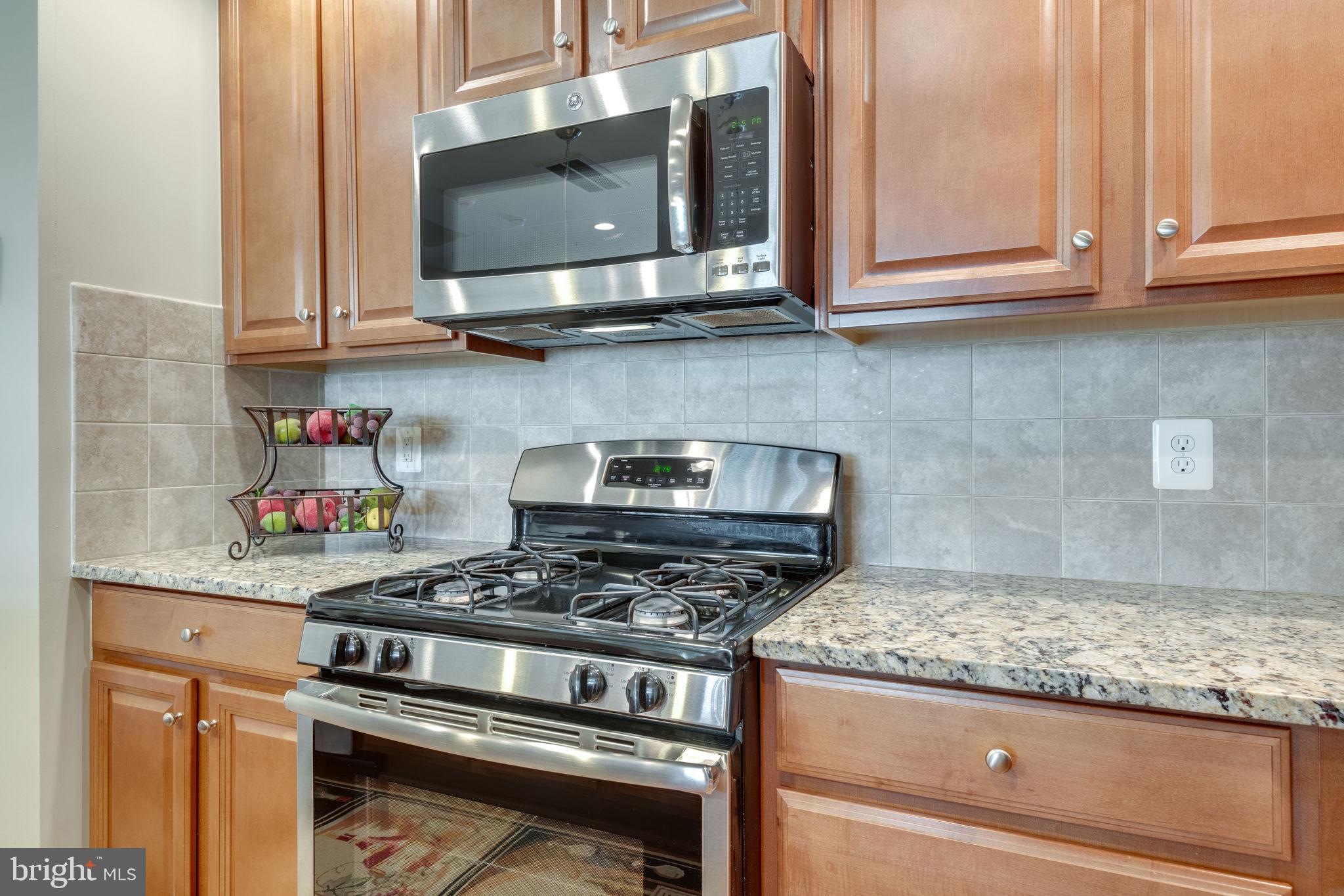7450 Brunson Circle Gainesville, VA 20155 - Photo 12 of 39 Gas range and built in microwave -- vents outside