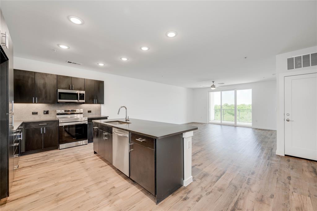 a kitchen with a stove a sink and a microwave