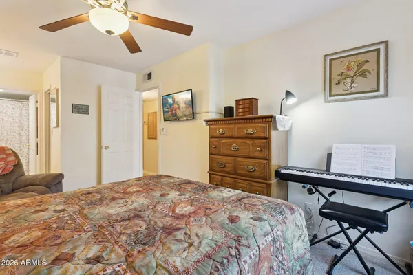 a bedroom with a bed and a lamp