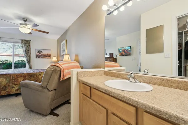 a bathroom with a granite countertop sink a toilet a shower and a mirror