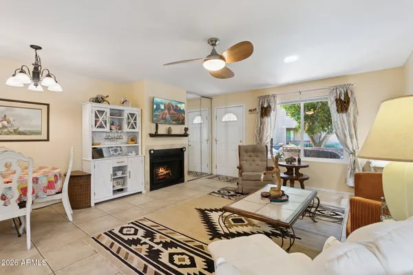 a living room with furniture fireplace and a large window