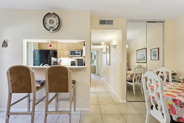 a dining room with wooden floor and chandelier