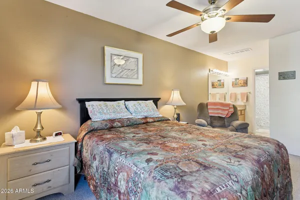 a bedroom with a bed couch and window