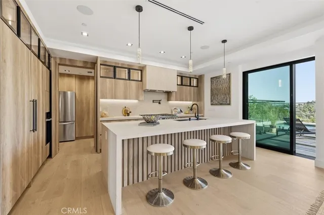 a kitchen with stainless steel appliances a sink stove and cabinets