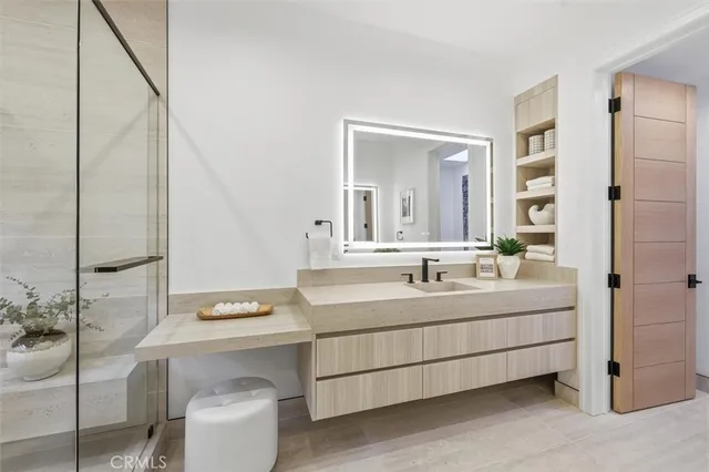 a kitchen with a refrigerator and white cabinets