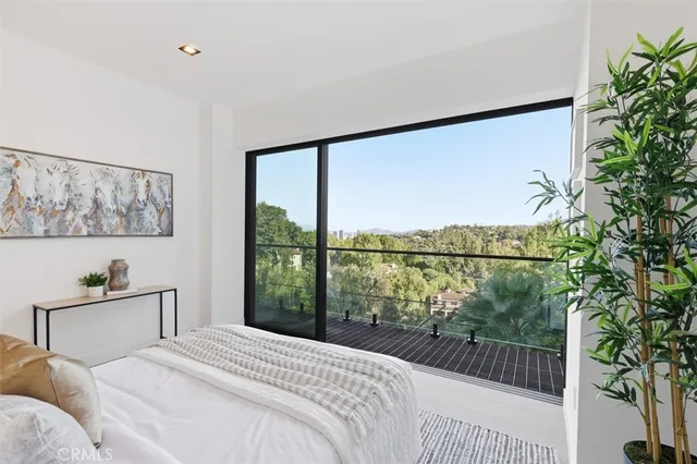 a dining room with furniture and a floor to ceiling window