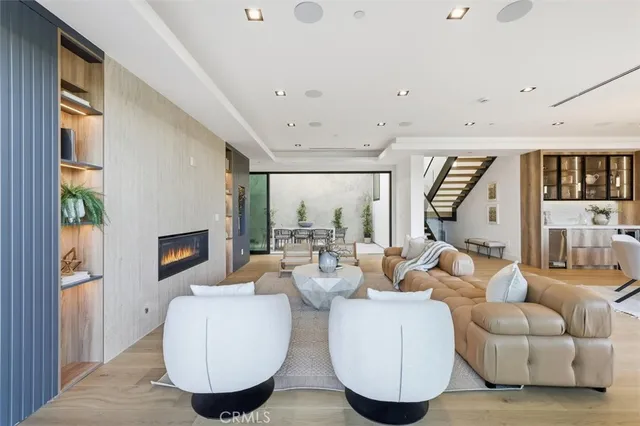 a living room with furniture and a floor to ceiling window