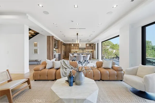 a living room with furniture or chandelier and a large window