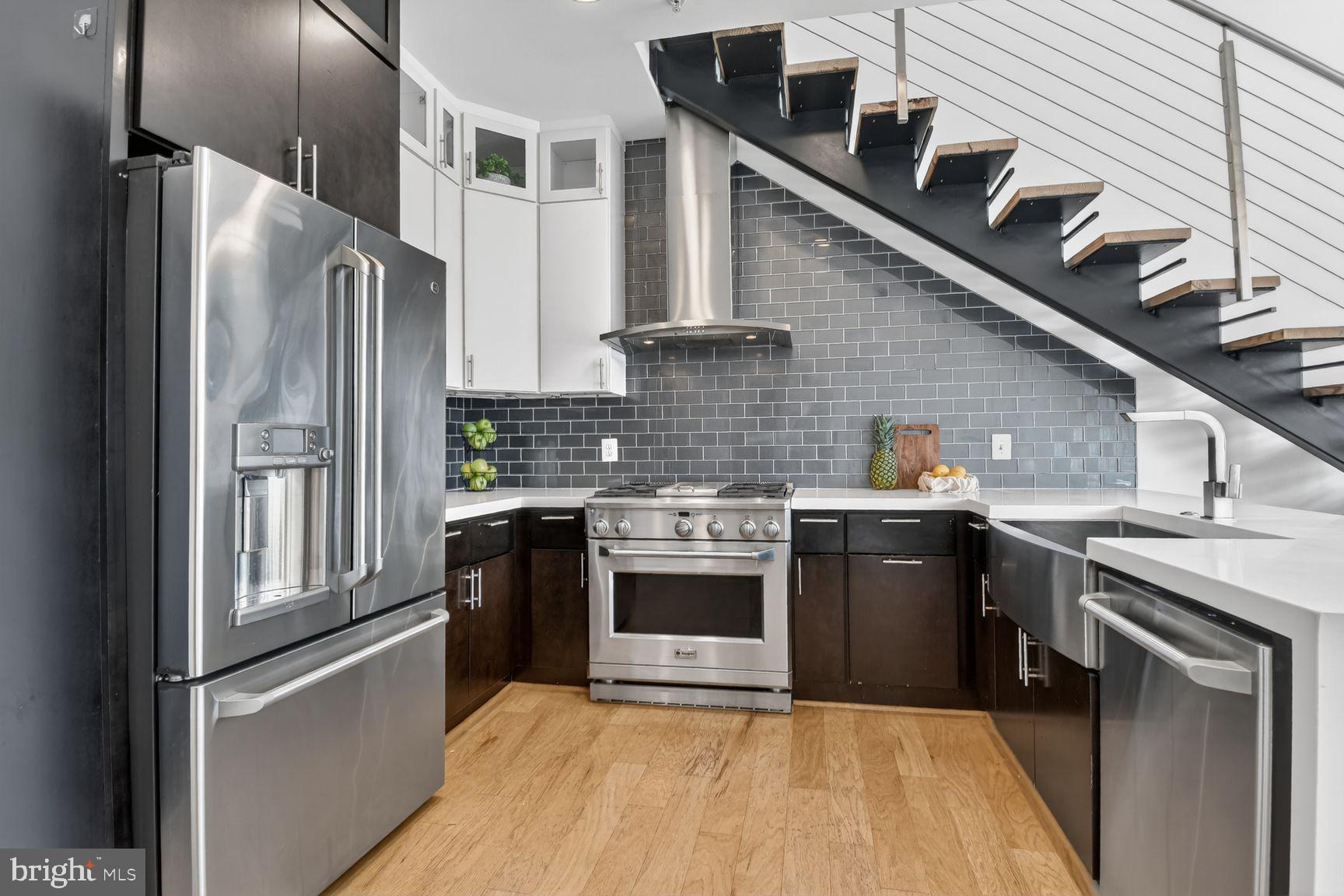 1443 Chapin Street Northwest, Unit 403 Washington, DC 20009 - Photo 7 of 24 a kitchen with stainless steel appliances granite countertop a refrigerator a stove and a sink