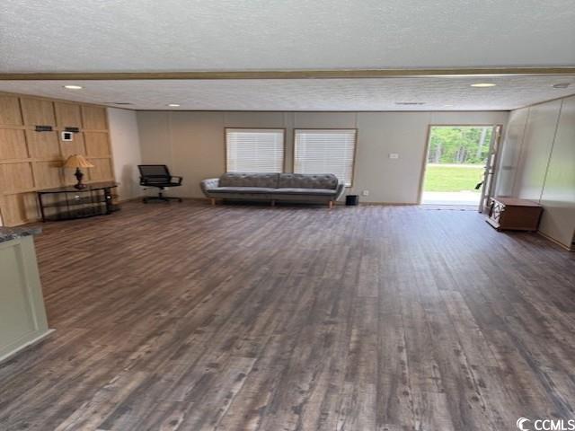65 Clemmons Drive Tabor City, NC 28463 - Photo 12 of 29 Living area with dark wood-style flooring and a textured ceiling