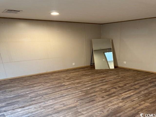 65 Clemmons Drive Tabor City, NC 28463 - Photo 14 of 29 Spare room featuring wood finished floors, ornamental molding, baseboards, and recessed lighting