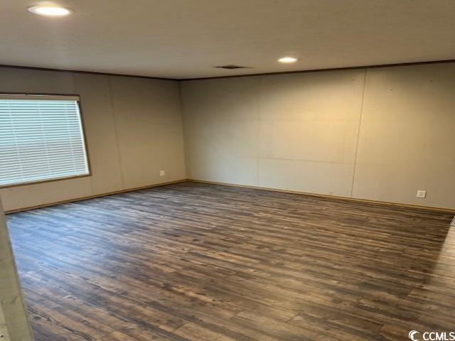 65 Clemmons Drive Tabor City, NC 28463 - Photo 15 of 29 Empty room featuring wood finished floors, recessed lighting, and baseboards