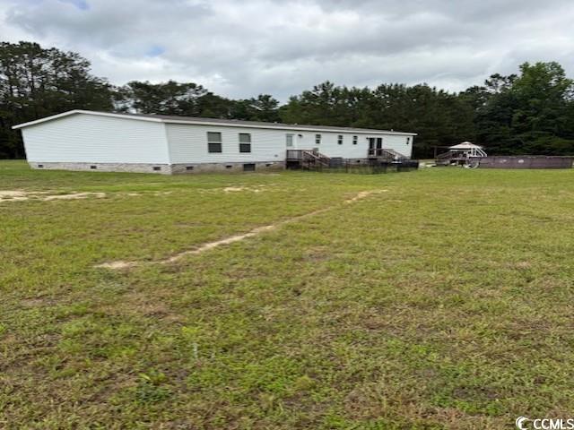 65 Clemmons Drive Tabor City, NC 28463 - Photo 2 of 29 Rear view of house featuring crawl space and a lawn
