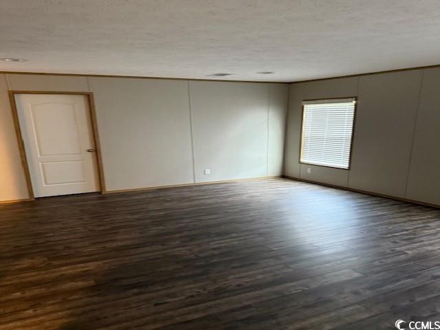 65 Clemmons Drive Tabor City, NC 28463 - Photo 27 of 29 Spare room featuring dark wood-type flooring and baseboards