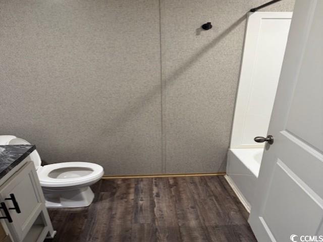 65 Clemmons Drive Tabor City, NC 28463 - Photo 28 of 29 Full bathroom with wood finished floors, vanity, toilet, and a tub