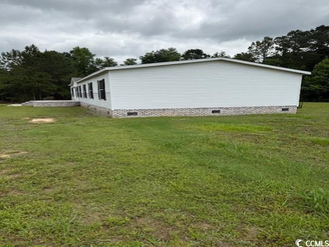 65 Clemmons Drive Tabor City, NC 28463 - Photo 5 of 29 View of property exterior featuring crawl space and a lawn