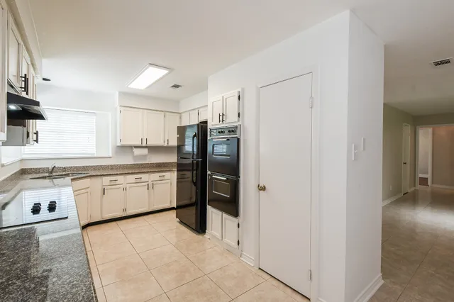 a kitchen with stainless steel appliances a refrigerator sink and cabinets